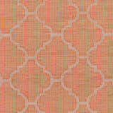 Close-up of Unique Outdoor Trellis Area Rug, rust red color. Geometric trellis pattern, woven texture. Swatch