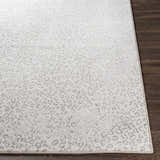 Close-up of the Keenes Leopard Print Area Rug showing its charcoal and cream animal pattern and machine woven texture. Front