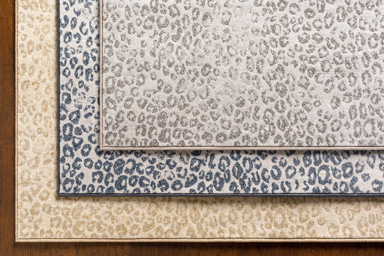 Close-up of Keenes Leopard Print Area Rug in charcoal, cream, and light gray colors and animal print pattern. Styleshot