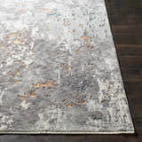 Close up of Kenedy Carved Statement Carpet in blue, charcoal, and ivory on dark wood floor. Contemporary style. Front