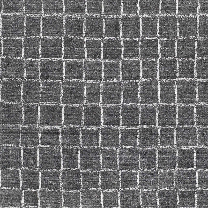Close-up of Kenesaw Clearance Rug. Charcoal rug with a contemporary white square grid pattern. Hand-knotted viscose texture. Swatch