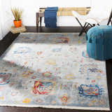 Entryway scene with a Kernersville Area Rug, blue ottoman, white chair, and wooden bench with a blue throw. Roomscene-Rectangle