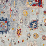 Close-up of the Kernersville Area Rug featuring a traditional floral pattern in blue, burnt orange, and light beige. Swatch