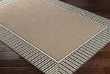 Close-up of the Kidron Area Rug; beige center with a black and beige striped border on dark wood flooring. Corner