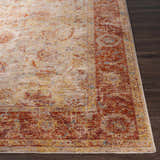 Close-up of the Kilsby Area Rug showing its traditional design, warm reds, yellows, and blues on a neutral background. Front