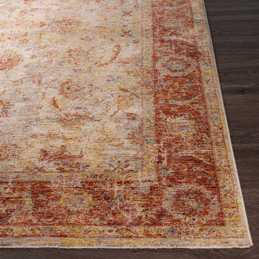 Close-up of the Kilsby Area Rug showing its traditional design, warm reds, yellows, and blues on a neutral background. Front