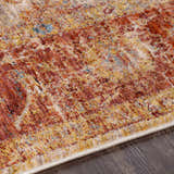 Close-up of the Kilsby Area Rug showing its traditional pattern, warm rust, gold, and blue tones, and soft, textured weave. Texture