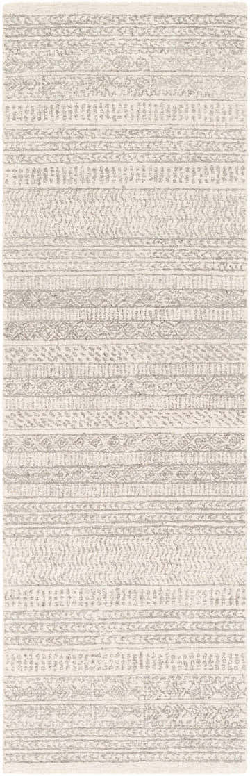 Close-up of the Kinmundy Tufted Maroc Wool Rug. Features gray and ivory hues in a textured, bohemian-inspired striped pattern. Design-Runner-268