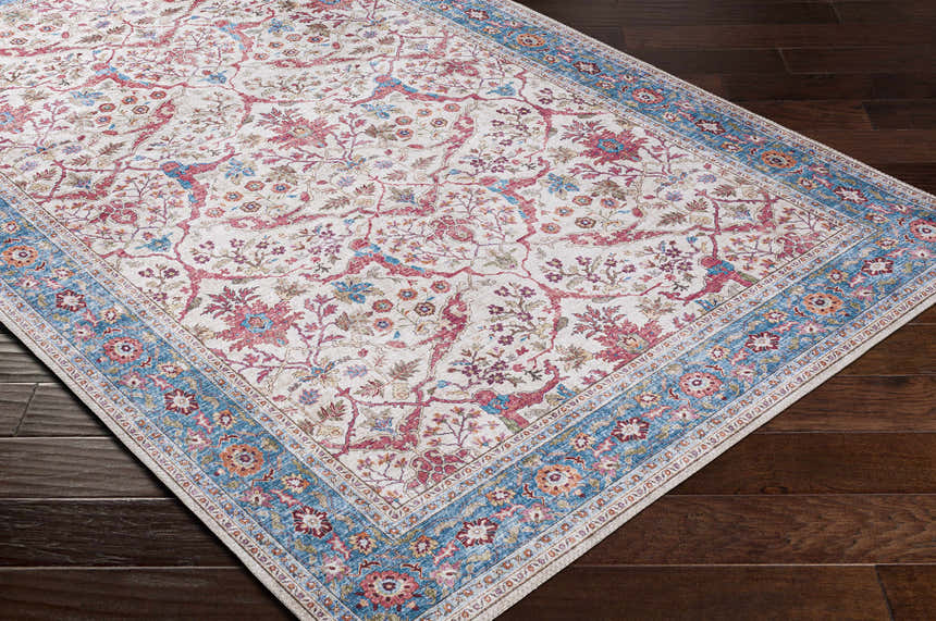 Close-up of the Kislingbury Area Rug showing its beige, blue, and burnt orange floral and bird pattern. Corner