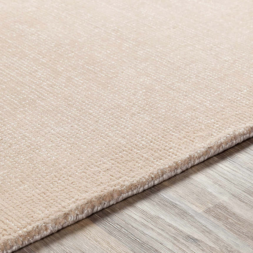 Close-up of the hand-loomed Klickitat Area Rug. Peach and white Tencel rug with subtle textured design. Texture