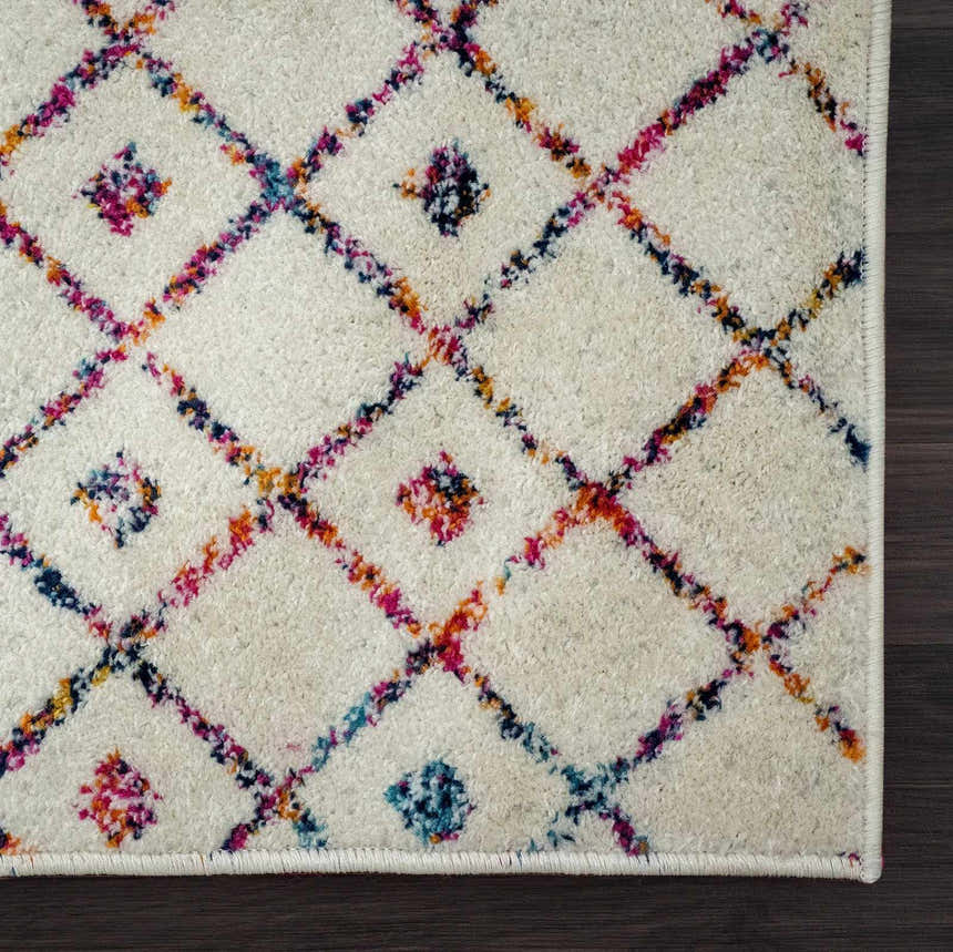Close-up of the Marash KMRSH-4600 area rug. Off-white rug with colorful diamond pattern in blue, purple, red, and orange. Swatch