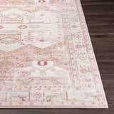 Close-up of the Kendal Area Rug. Cream, light beige, and pale pink oriental design on dark wood floors. Front