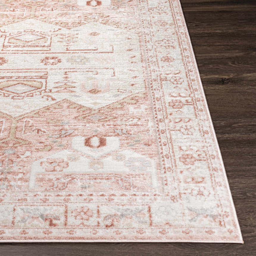 Close-up of the Kendal Area Rug. Cream, light beige, and pale pink oriental design on dark wood floors. Front