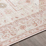 Close-up of the Kendal Area Rug showing cream, beige, and pale pink traditional design and soft texture. Texture