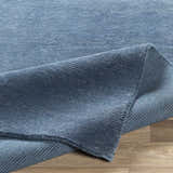 Close up of the blue Kendall Carpet showing its hand knotted texture and wool viscose blend. Fold