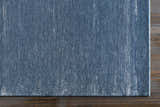 Close-up of the blue Kendall Carpet showing its hand-knotted texture and subtle vertical stripe design. Corner