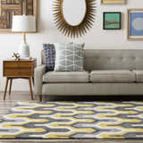 Living room scene with a gray sofa and the Knighton Area Rug in charcoal, mustard, slate blue, and white. Roomscene-Rectangle