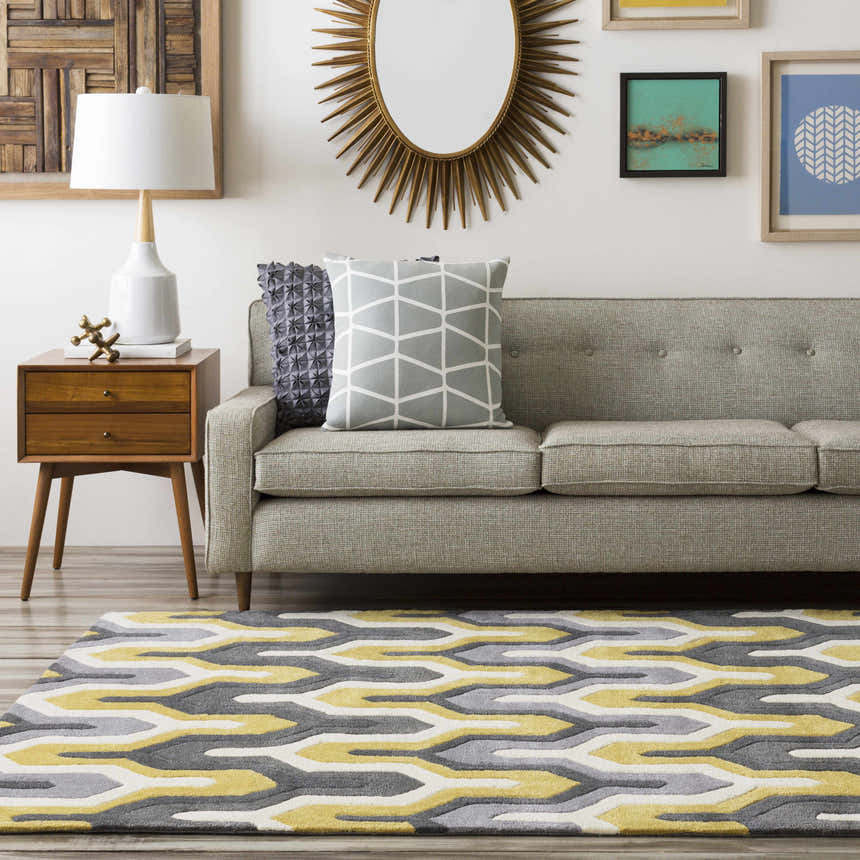 Living room scene with a gray sofa and the Knighton Area Rug in charcoal, mustard, slate blue, and white. Roomscene-Rectangle