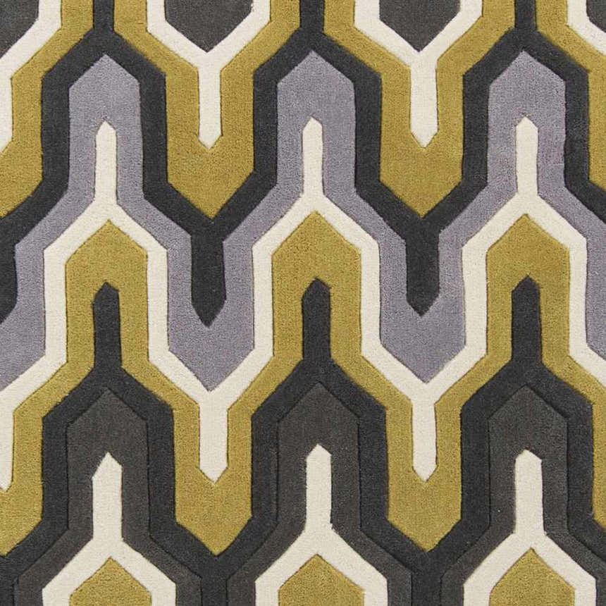 Close-up of the hand-tufted Knighton Area Rug. Geometric pattern in charcoal, mustard, slate blue, and white. Swatch