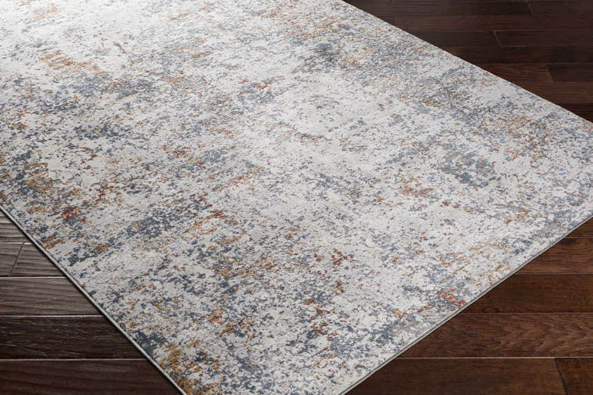 Close-up of Kearny Area Rug showing its contemporary brick red, brown, charcoal, and gray abstract design. Corner