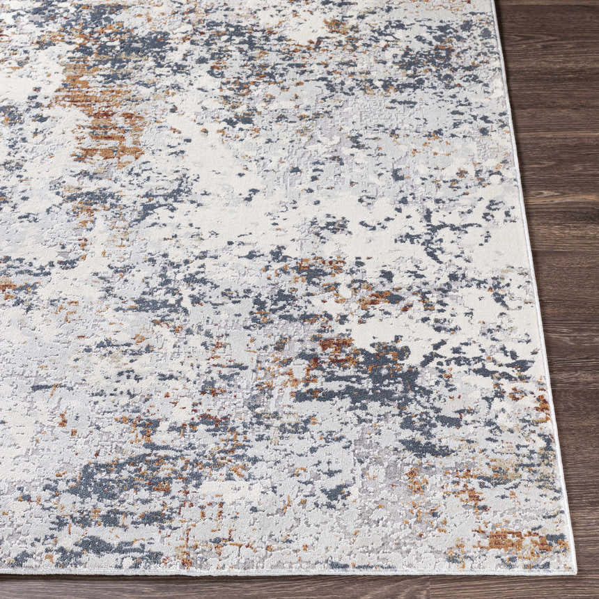 Close-up of the Kearny Area Rug, a contemporary design in brick red, brown, charcoal, and light gray. Front