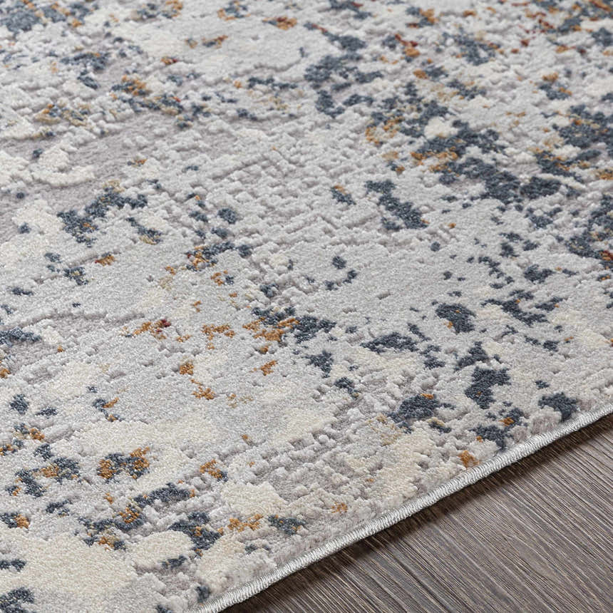 Close-up of the Kearny Area Rug showing its light gray, charcoal, and brick red contemporary pattern. Texture