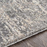 Close up of the Kyabram textured abstract area rug. Beige, charcoal, gray, and off white tones. Texture