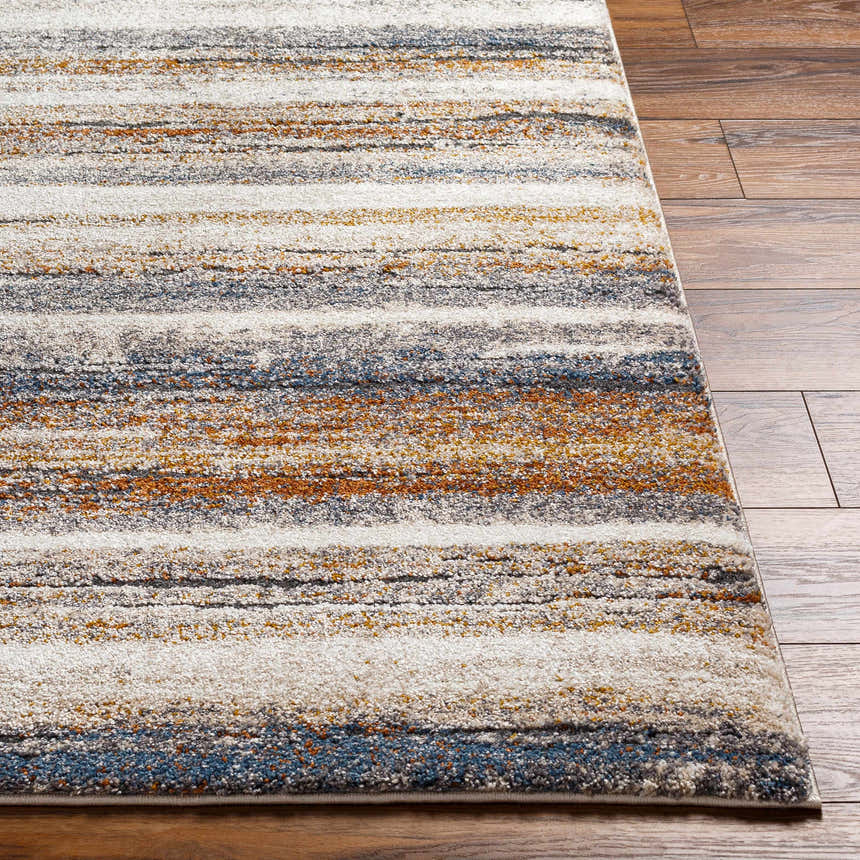 Close-up of the Kylo Area Rug showing a geometric striped pattern in dark beige, brown, mocha, and off-white on wood flooring. Front