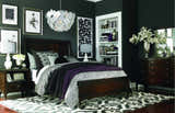 Bedroom with dark walls, wood furniture, and a black and cream Landa Area Rug. Roomscene-Rectangle
