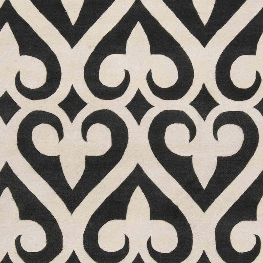 Close-up of the Landa Area Rug showing its black and cream, heart-like geometric pattern. Swatch