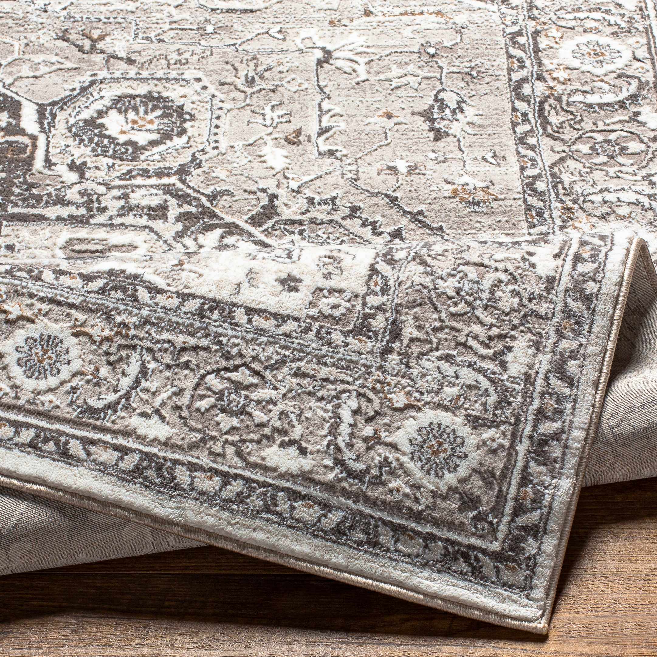 Folded section of Langcangan Area Rug - Clearance, displaying material thickness and weave. Traditional Area Rug Backing  