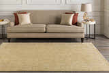 Living room scene with a tan sofa, side tables, and the Langhorne Carpet in a muted tan color. Roomscene-Rectangle