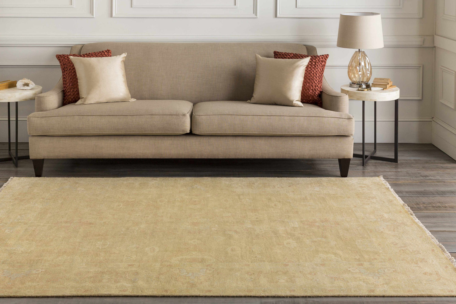 Living room scene with a tan sofa, side tables, and the Langhorne Carpet in a muted tan color. Roomscene-Rectangle