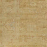 Close-up of the hand-knotted Langhorne Carpet, a traditional rug in tan, dusty pink, and mustard tones. Wool texture detail. Swatch
