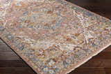 Close-up of the Lappe Area Rug. Bohemian style rug in cream, dark blue, peach, and rust colors on dark hardwood floor. Corner