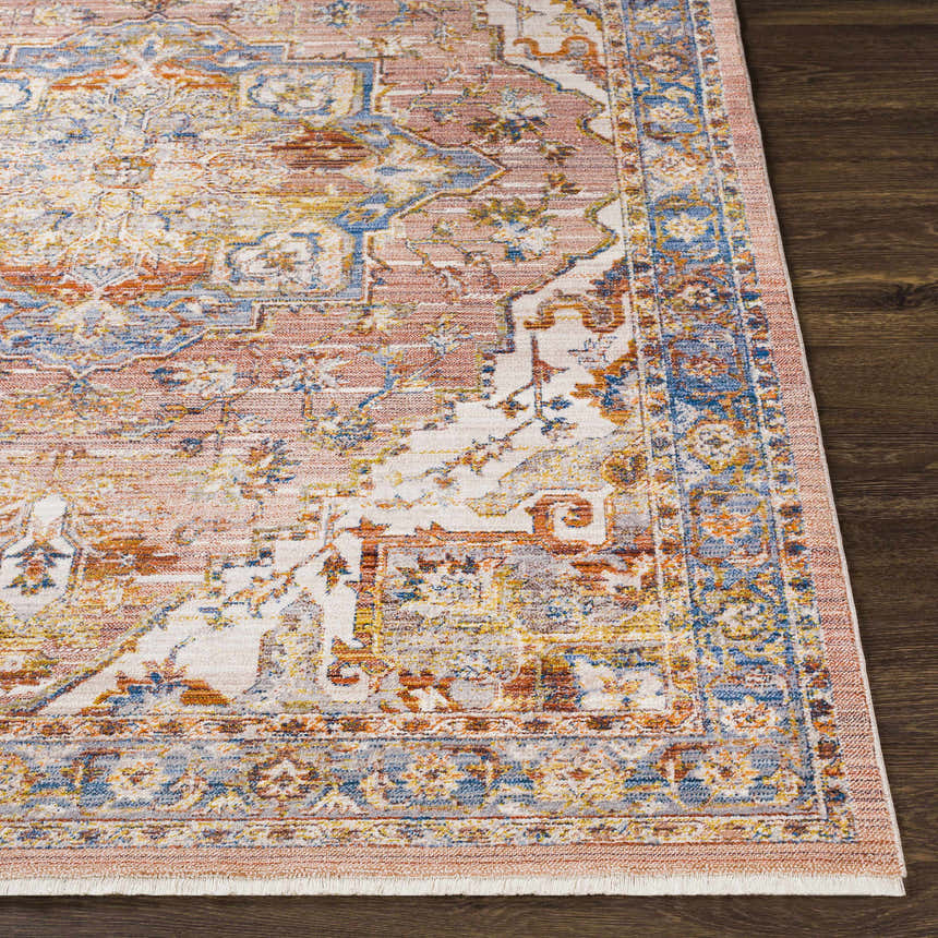 Close-up of Lappe Area Rug: Cream, dark blue, and rust colors with a traditional, bohemian-inspired pattern. Polyester texture. Front