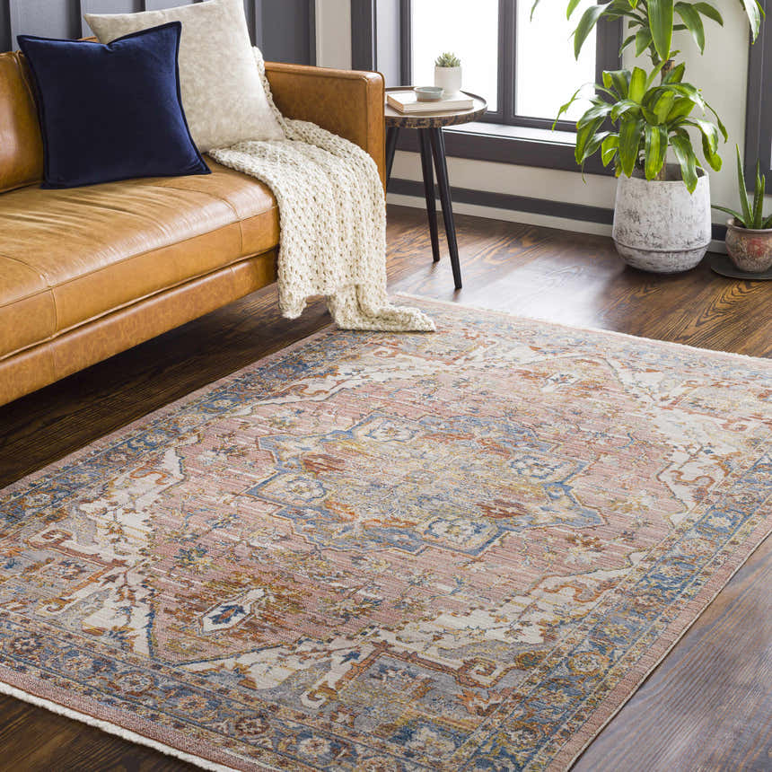 Living room with a brown leather sofa and Lappe Area Rug in cream, blue, peach, and gray oriental pattern. Roomscene-Rectangle