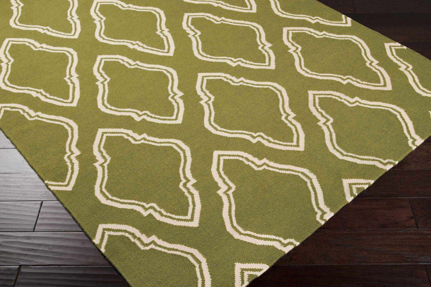 Close-up of the Larimore Area Rug in olive and peach, featuring a hand-woven contemporary design. Corner