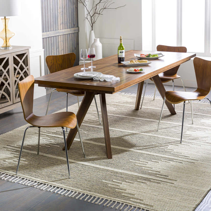 Dining room scene with a Lucasville area rug, wood table, mid-century chairs, and modern decor. Roomscene-Rectangle