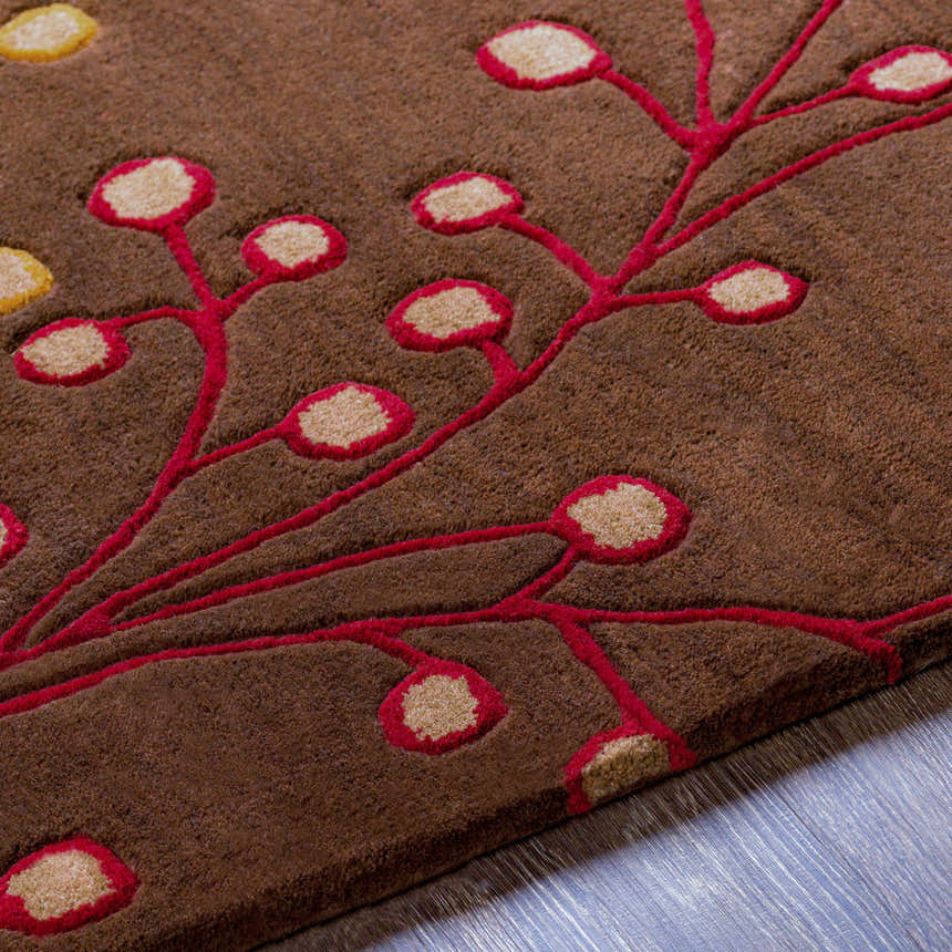 Close up of the Brown Elsu Area Rug showing the floral pattern with burgundy and tan accents on a brown wool rug. Texture