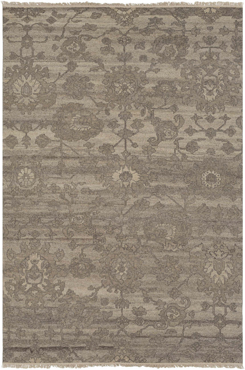 Close-up of the Lerwick Carpet, a hand-knotted wool rug with a traditional floral pattern in beige, charcoal, and brown tones. Design-Rectangle