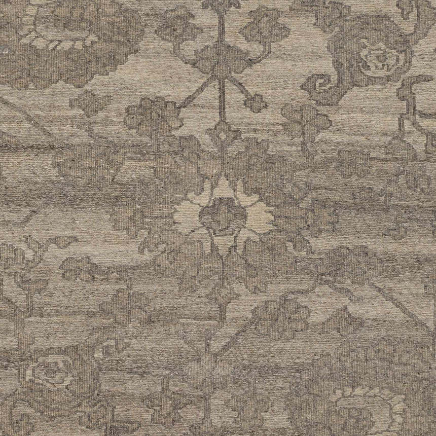 Close-up of the Lerwick Carpet showing its beige and charcoal floral pattern and hand-knotted wool texture. Swatch