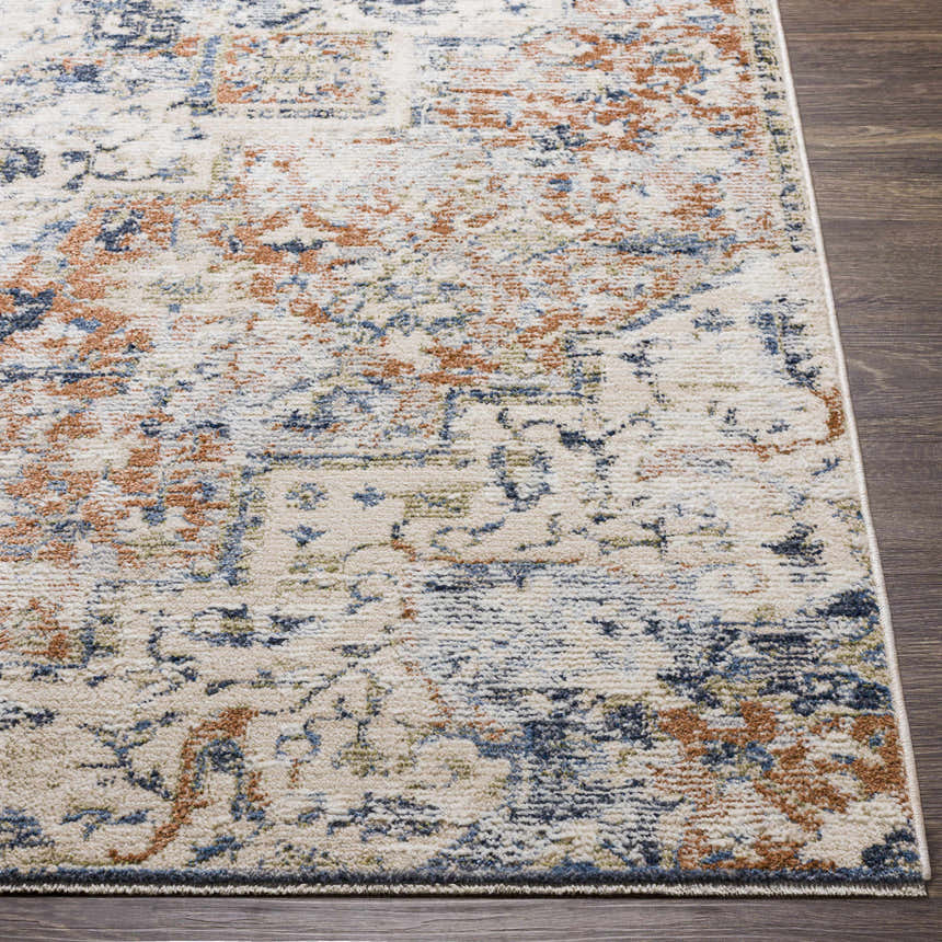 Close-up of the Loughrea Area Rug showing its brick red, cream, and denim bohemian pattern and soft texture. Front