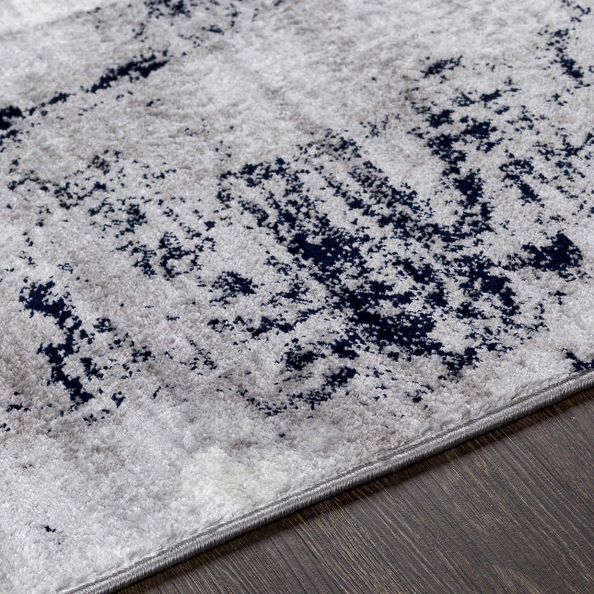 Close up of Limao Abstract Denim Area Rug showing texture and abstract denim and gray pattern. Texture