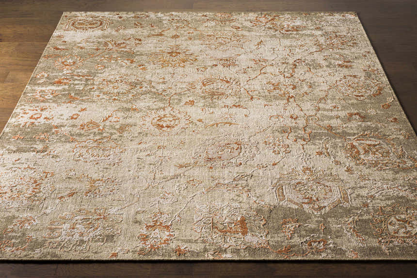 Close-up of the Limay Premium Wool Rug. Bohemian style rug with brick red, beige, and olive floral pattern. Front