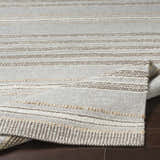 Close-up of the Allendorf Area Rug showing beige, cream, and charcoal horizontal stripes and hand-woven texture. Fold