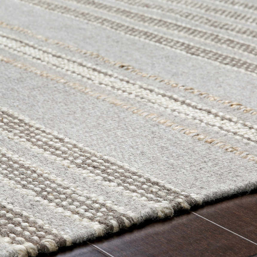 Close-up of the hand woven Allendorf Area Rug. Beige, cream, and charcoal stripes add texture to this wool rug. Texture