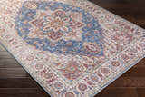 Close-up of the Kapaa Blue Medallion Rug, showcasing its traditional floral pattern in beige, blue, and burnt orange tones. Corner