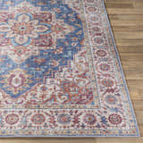 Close-up of the Kapaa Blue Medallion Rug showing its traditional beige, blue, and burgundy floral pattern and machine-woven texture. Front