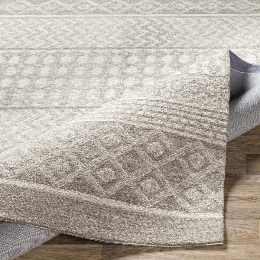 Close-up of the Lone Beige Tufted Maroc Wool Rug showing its geometric pattern and tufted texture. Fold